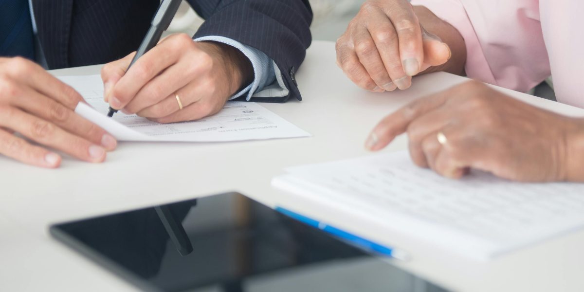 A client meeting with a property advisor, discussing selection criteria for a property manager.