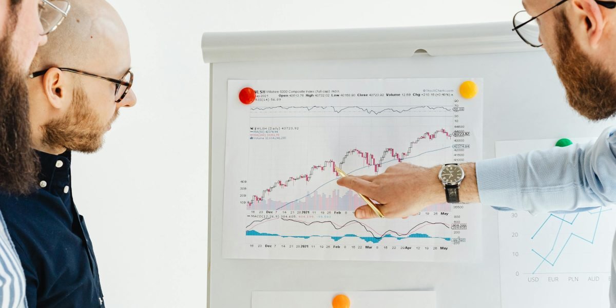 A team of professionals collaborates, discussing strategic financial decisions for their portfolio.