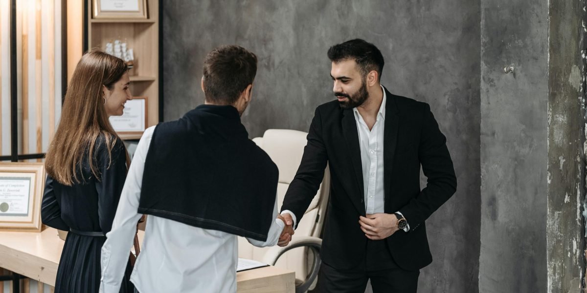 A property manager discussing details with a client, representing reliable property management services.