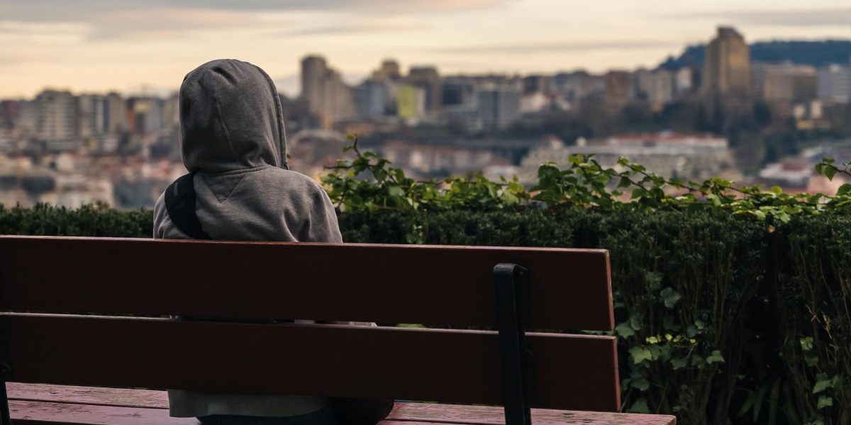 A person looks out over the vibrant Dubai skyline, contemplating the exciting yet potentially overwhelming process of finding a new home in the bustling city.