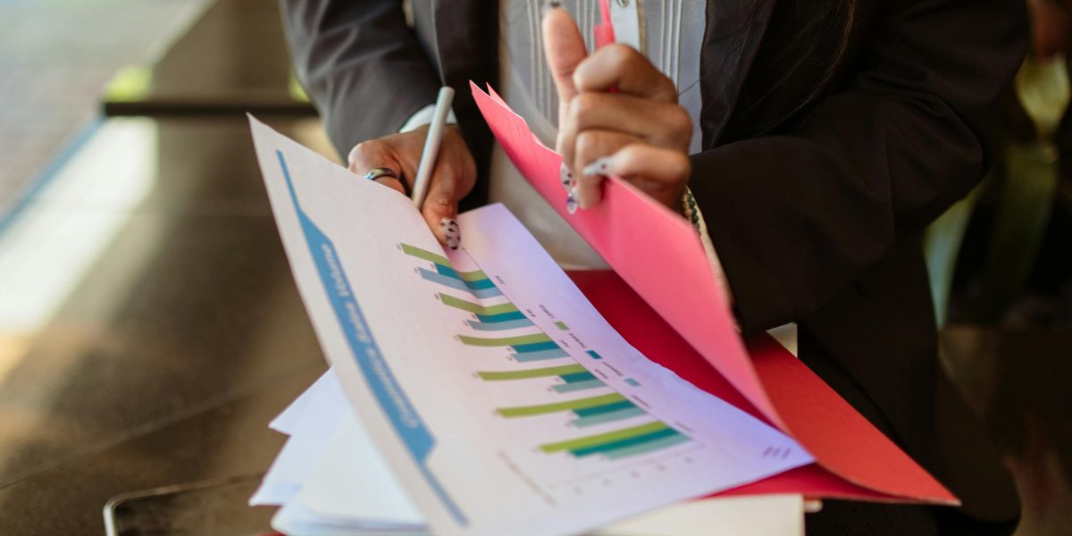 A person meticulously reviewing financial documents and calculations, emphasizing the importance of thorough budgeting for rental expenses.