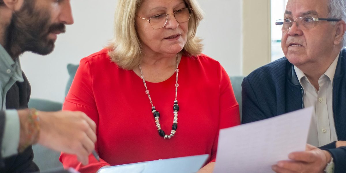 A professional guiding a client through complex rental information and fees.