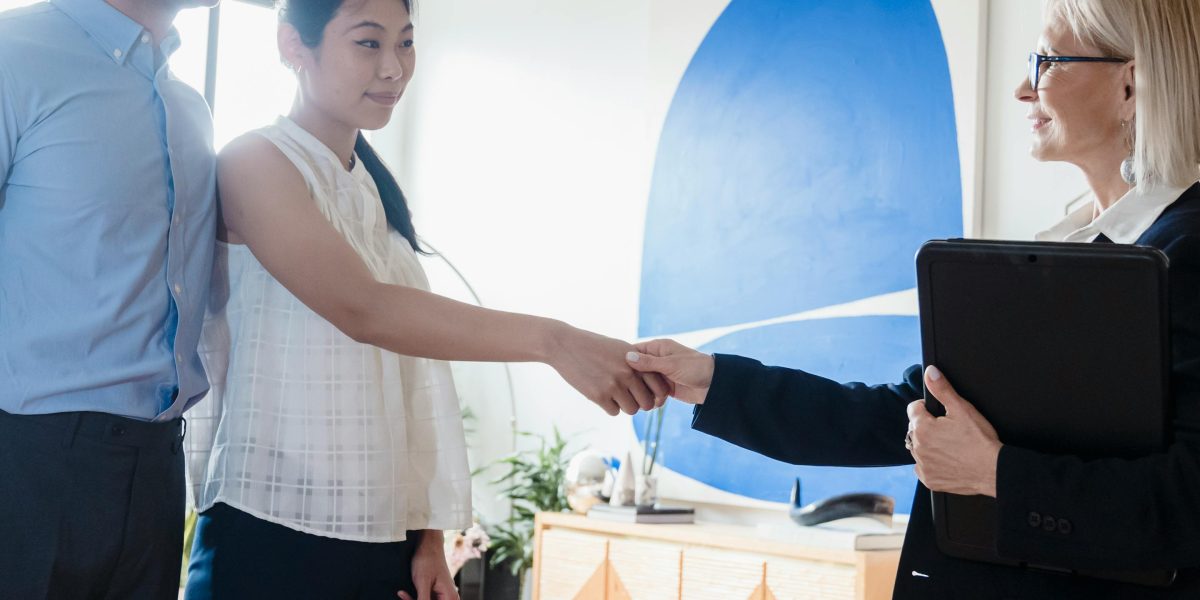 A client and a trusted agent concluding a successful discussion with a handshake, symbolizing agreement and trust.