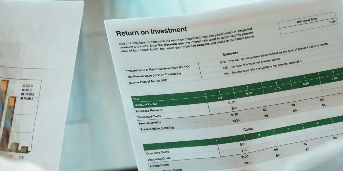 Professionals reviewing financial documents or market reports, analyzing investment performance and trends.