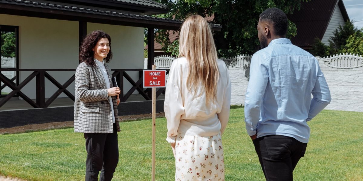 A group of individuals thoughtfully discussing various property investment opportunities in a modern setting.
