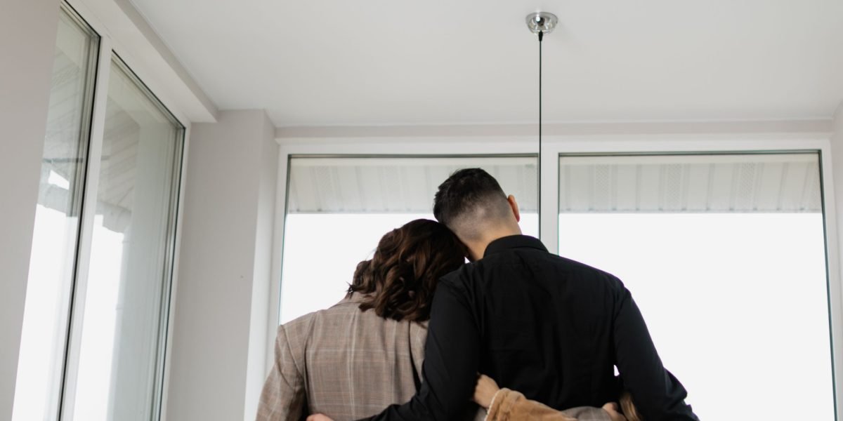 A family exploring a spacious, modern villa, imagining their future life in a new home.