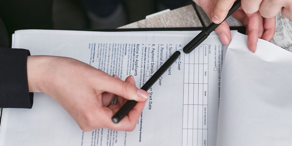 Professionals meticulously reviewing a legal contract, ensuring all terms and conditions are clearly understood.
